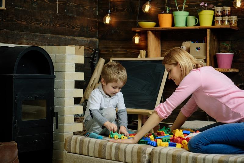 A childcare worker plays with a young child